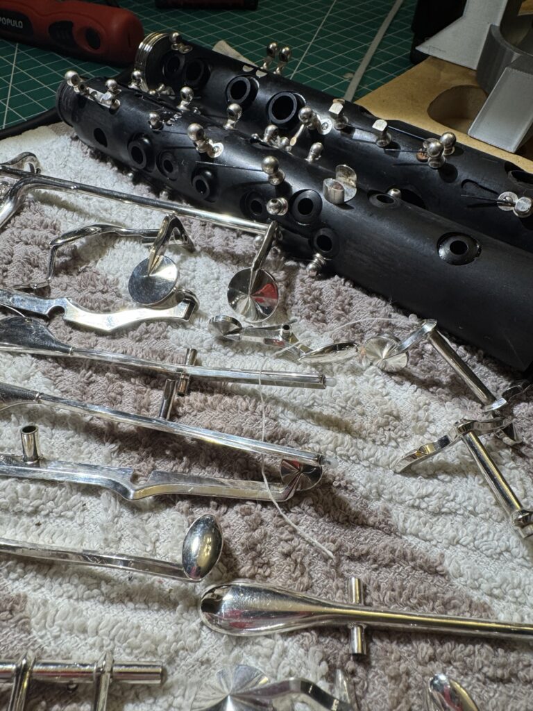Disassembled clarinet parts on towel